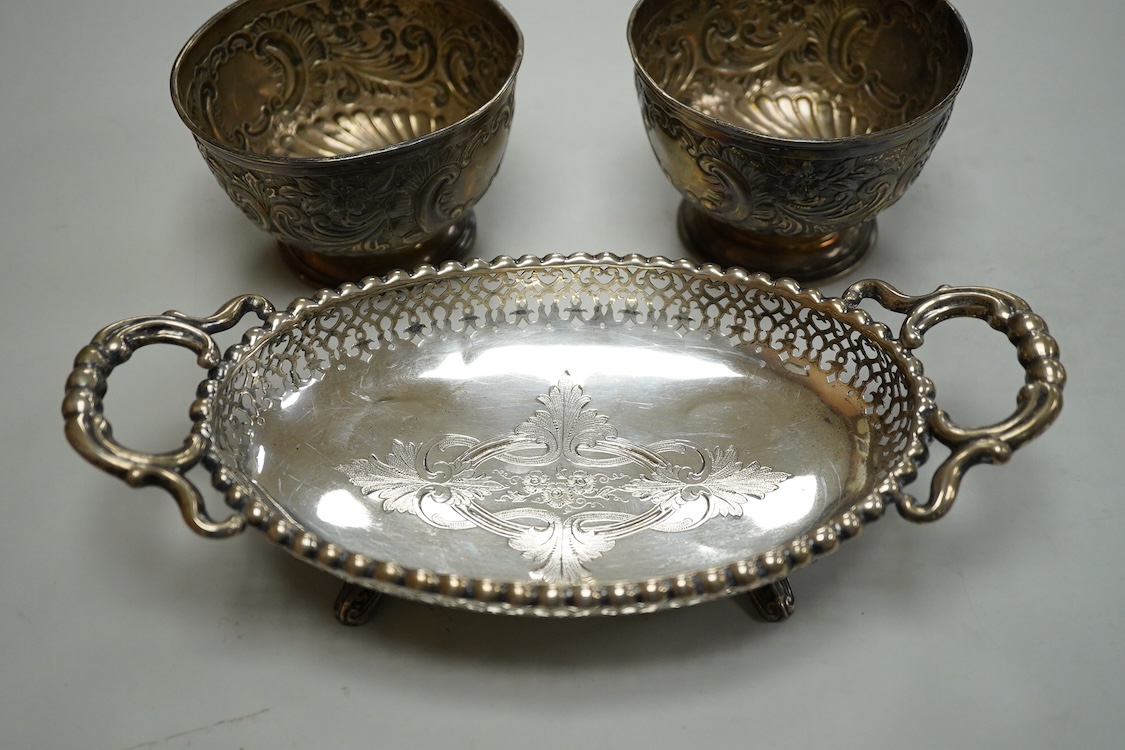 A pair of Edwardian repousse silver pedestal bowls, by Charles Boyton & Son Ltd, London, 1906, diameter 11.4cm(a.f.), 6.9oz and a plated two handled dish.